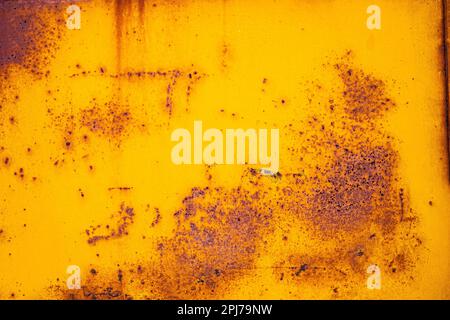 Rust on yellow paint form an intriguing abstract pattern Stock Photo