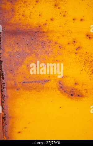 Rust on yellow paint form an intriguing abstract pattern Stock Photo
