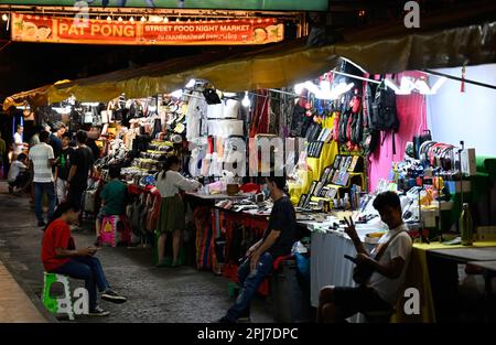 A general view of a night market stall. Bangkok’s infamous red-light entertainment district, Patpong, has reopened since the covid-19 pandemic. It has resurfaced as a street food night market with only a few remaining go go bars, 2 streets also offering souvenirs, clothing and trinkets. Since marijuana was legalised on June 9 marihuana outlets have also opened in the area. Stock Photo