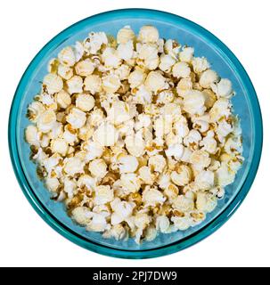 Round glass bowl full of popcorn isolated on white background. Stock Photo