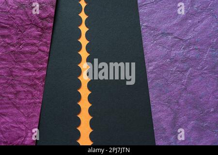 textured purple paper, black cards with decorative borders and orange line Stock Photo