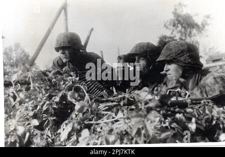 World War Two B&W photo German Soldiers with an MG34 in a camouflged Position during Operation Barbarossa 1941 .  The men are from the 2nd SS Division Das Reich early in the Russian Campaign SS KB Fendt Stock Photo