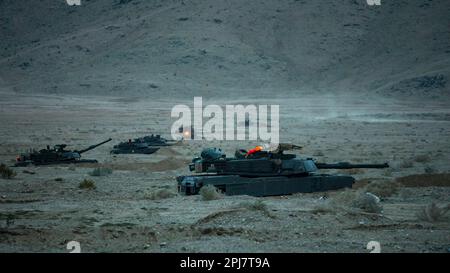 U.S. Army Soldiers assigned to the 'Hound Battalion,' 3rd Battalion, 67th Armored Regiment, 2nd Armored Brigade Combat Team, 3rd Infantry Division, form a defensive line with modernized M1A2 SEPv3 Abrams tanks at the National Training Center, Fort Irwin, California, March 10, 2023. The Spartan Brigade, the Army’s most modernized brigade, completed its rotation NTC 23-05, making it not only the best equipped but most lethal unit in America’s arsenal as the Army moves toward building the Army of 2030. (U.S. Army photo by Sgt. Dre Stout, 50th Public Affairs Detachment) Stock Photo