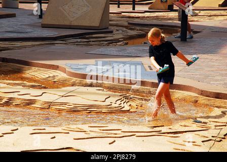 A young girl wades in a scale model of the Mississippi River at Mud Island in Memphis, Tennessee Stock Photo