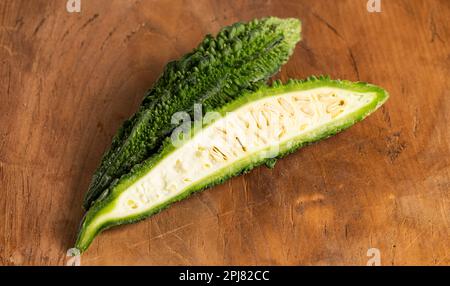 Green Bitter Gourd Melon on a Wooden Table Stock Photo