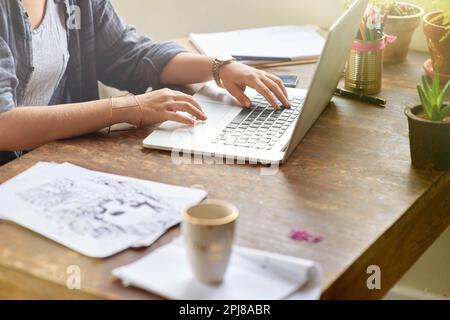 Shes in her creative zone. a young graphic designer working on her laptop at home. Stock Photo