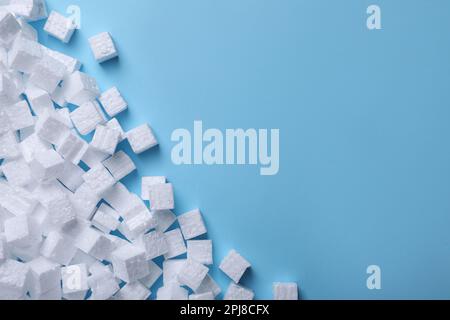 Many styrofoam cubes on light blue background, flat lay. Space for text Stock Photo