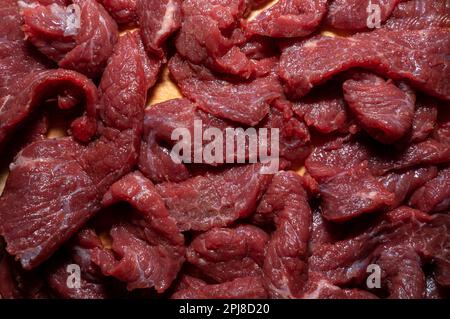 Lots of chopped pieces of raw beef Stock Photo