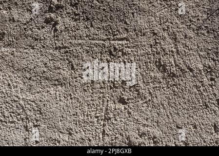 Rough background of gray concrete wall surface with highly highlighted texture. Stock Photo