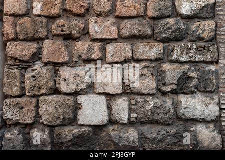 Stone and brick wall of an ancient building. Suitable as background and wallpaper pattern. Stock Photo