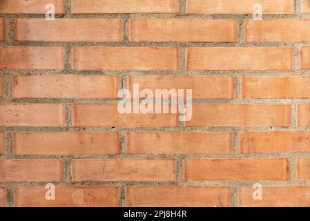 Wall made of red bricks, suitable as background or wallpaper pattern. Stock Photo