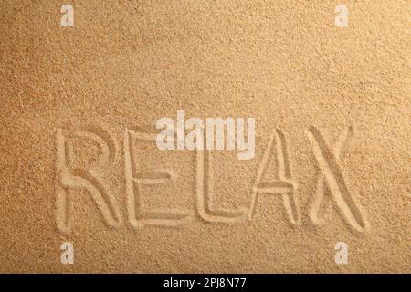Inscription Relax in the sand on a tropical island. Top view Stock Photo