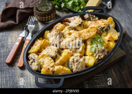 Fish casserole mackerel, potato with cheese and creamy sauce. Greek food. Stock Photo