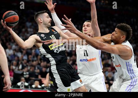 Belgrade. 31st Mar, 2023. Partizan's Ioannis Papapetrou (L) vies with Real Madrid's Mario Hezonja (C) and Walter Tavares (R) during the regular season round 32 Euroleague basketball match between Partizan and Real Madrid in Belgrade, Serbia on March 31, 2023. Credit: Predrag Milosavljevic/Xinhua/Alamy Live News Stock Photo