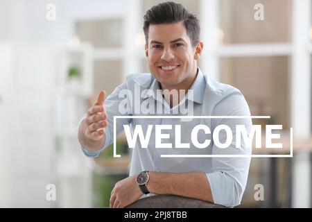 Happy businessman offering handshake indoors, focus on hand. Welcome to team Stock Photo