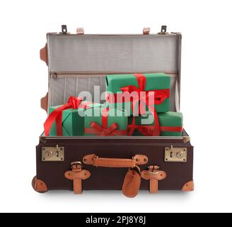 Beautiful green gift boxes with red bows in retro suitcase on white background Stock Photo