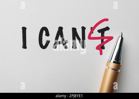 Phrase I CAN'T with crossed out letter T and pen on white background, top view. Motivation and positivity Stock Photo