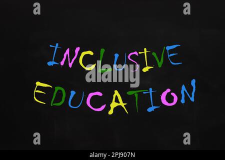 Phrase INCLUSIVE EDUCATION written on blackboard. DEI concept Stock Photo