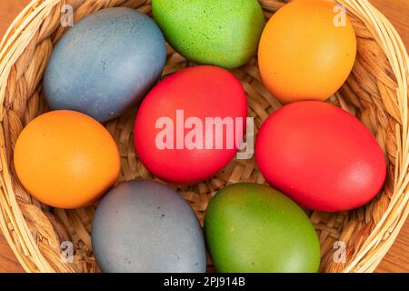 Easter eggs, dyed hen eggs in a wicker basket Stock Photo