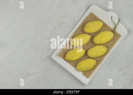 Raw meat rissoles on a cutting board. Ready for cooking. Frozen cutlets. Top view. Space for text. Stock Photo