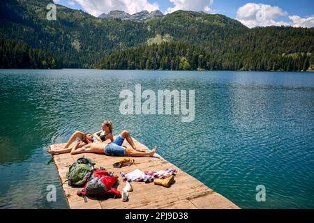 Couple Enjoying Near lake.Young man and girl in love flirting Stock Photo