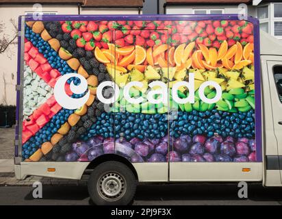 Closeup of fresh fruits on the side of an Ocado delivery van on a suburban street in London, England, UK Stock Photo