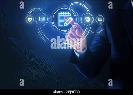 Man pointing at virtual icon of computer file on dark blue background, closeup Stock Photo