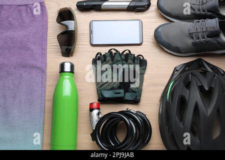 Flat lay composition with different cycling accessories on wooden background Stock Photo