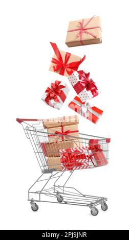 Beautifully wrapped gift boxes falling into metal shopping cart on white background Stock Photo
