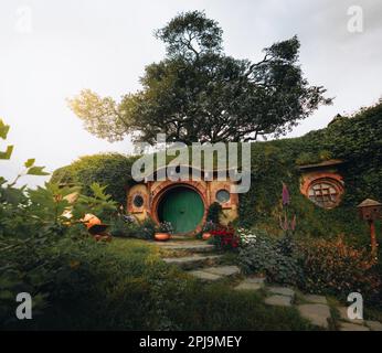 bilbo baggins home and hobbit garden in hobbiton movie set, new zealand. Taken during summer. Sunlight reflection. Travel and adventure concept. Stock Photo