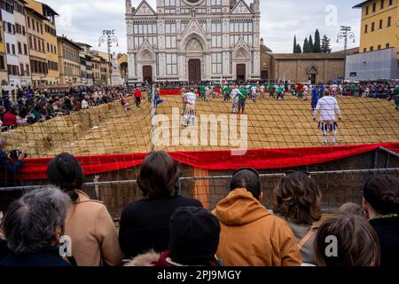 Crowd watches a game of Calcio Fiorentino in Piazza Santa Croce, Florence, Italy Stock Photo