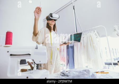 Costume designer using modern VR visual digital design technology in tailor studio Stock Photo