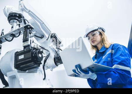 engineer woman worker working with robotic arm in productions lab research industry factory Stock Photo