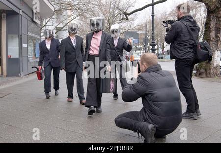 Berlin, Germany. 01st Apr, 2023. Activists of the group 'Extinction Rebellion' protest disused gas cans on their heads in front of the luxury sports car branch of Jaguar and Landrover on Kurfürstendamm for more determined political action against the climate crisis. Credit: Paul Zinken/dpa/Alamy Live News Stock Photo