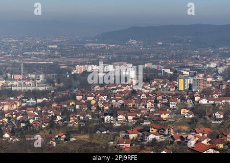 Cityscape of Banja Luka during sunny day, distant hill fade in hazy polluted air Stock Photo