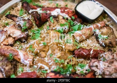 tandoori chicken and kebab served in steel plate at night Stock Photo