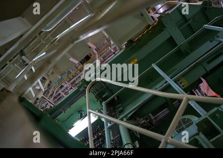 Ship's engine room. Vessel's ( Ship ) Engine Room Space / industrial stairs. Ship's Engine Heavy Machinery Space - Pipes, Valves, Engines Stock Photo