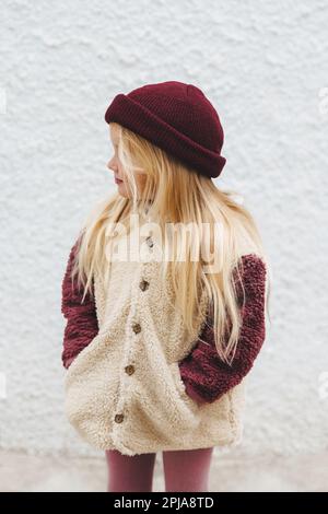 Child girl outdoor fashion outfit kid wearing hat and fluffy sherpa jacket winter stylish clothing 4 years old baby family lifestyle Stock Photo