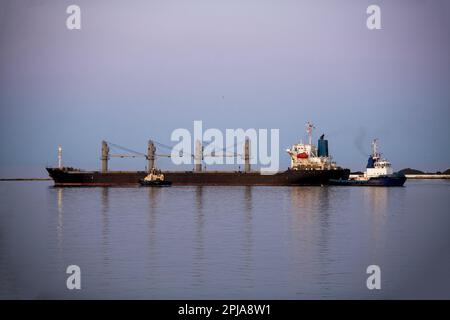 bulk carrier vessel is sailing in the port area. Stock Photo