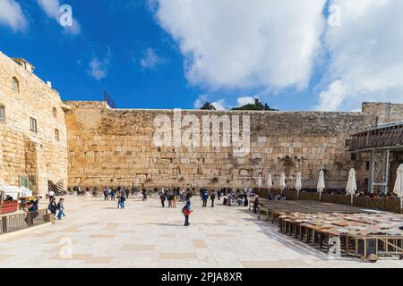 JERUSALEM, ISRAEL - JANUARY 14, 2023: Worshipers praying at the Western or Wailing Wall of Ancient Temple Stock Photo