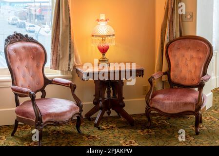 Antique table and chairs in the Cupola Suite of the historic Geiser Grand Hotel in Baker City, Oregon. Stock Photo