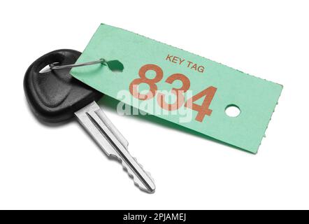Car key With Green Service Tag Cut Out on White. Stock Photo