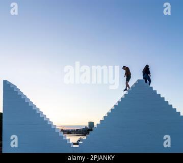 Bremen: sculpture 'Three Triangles' ('Outdoor Piece for Bremen'), by artist Sol LeWitt, persons climb on it, river Weser in , Bremen, Germany Stock Photo