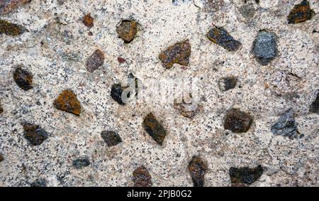 A stone wall with small stones in gray and brown Stock Photo