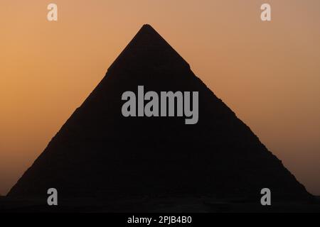 The Silhouette of the pyramid of Khafre at dusk / sunset in Giza, Egypt Stock Photo