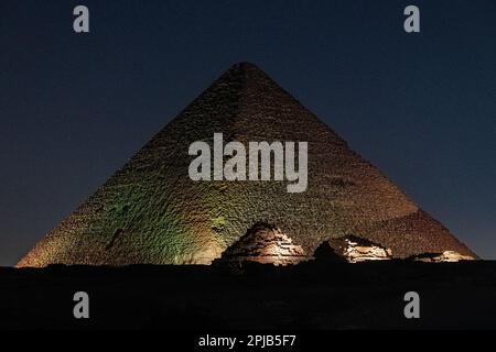 The Pyramids of Giza lit up with lights for the light and sound show at night in Egypt Stock Photo