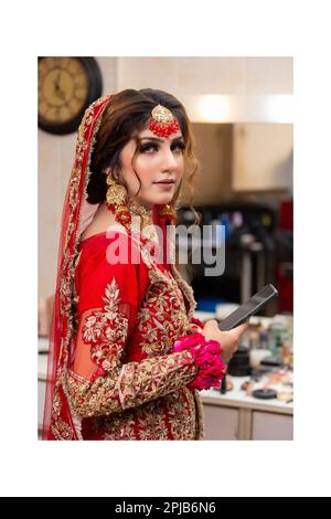 Indian bride dressed in traditional wedding clothes Stock Photo