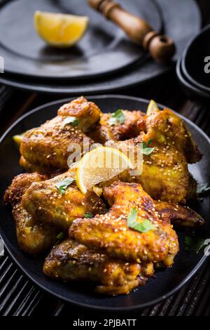Spicy chicken wings with garlic, sesame and lemon marinade in Asia style Stock Photo