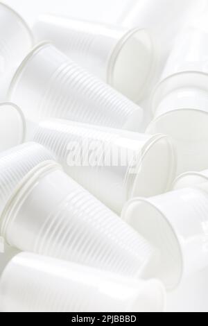 Disposable white plastic cups as background. Environmental concept. Non-compostable waste Stock Photo