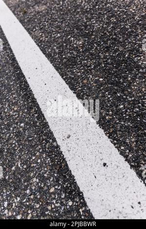 Old asphalt road with separation line. Selective focus Stock Photo